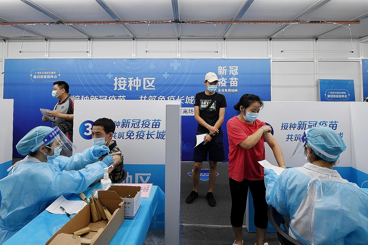 People receiving Covid-19 vaccine shots on Monday at a vaccination site in Guangzhou city, in China's Guangdong province. On Monday alone, 20 million people in China got their jabs.