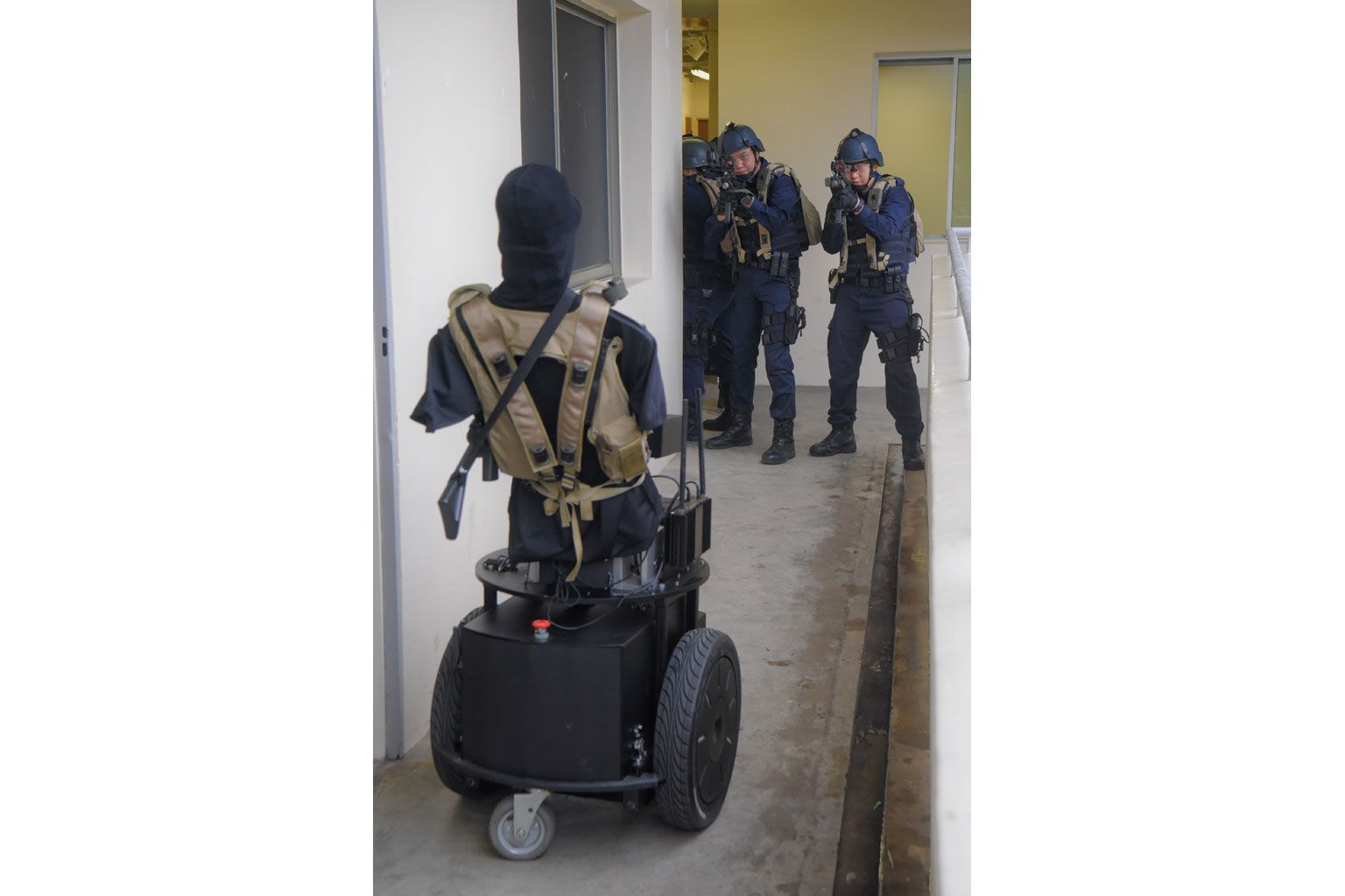 Police trainees demonstrating tactical movement against a bot, called the Force-On-Robotic Target (Fort), at the Home Team Academy Training Village last Friday.