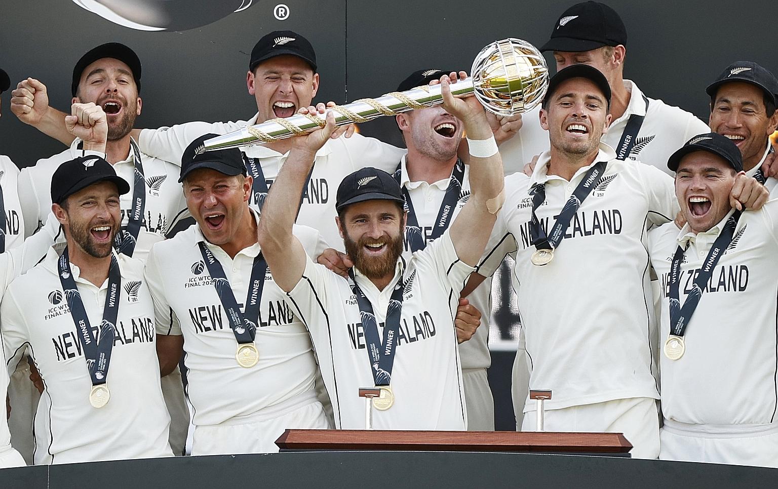 New Zealand captain Kane Williamson lifting the trophy to the joy of his teammates after beating India by eight wickets in the final of the World Test Championship in Southampton on Wednesday.