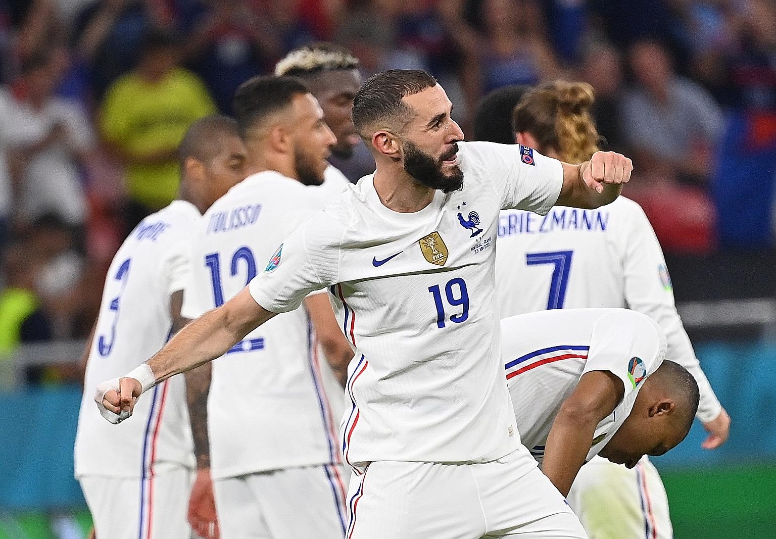 France's Karim Benzema celebrating his second goal in the 2-2 draw with Portugal on Wednesday. The draw ensured top spot for France in Group F.