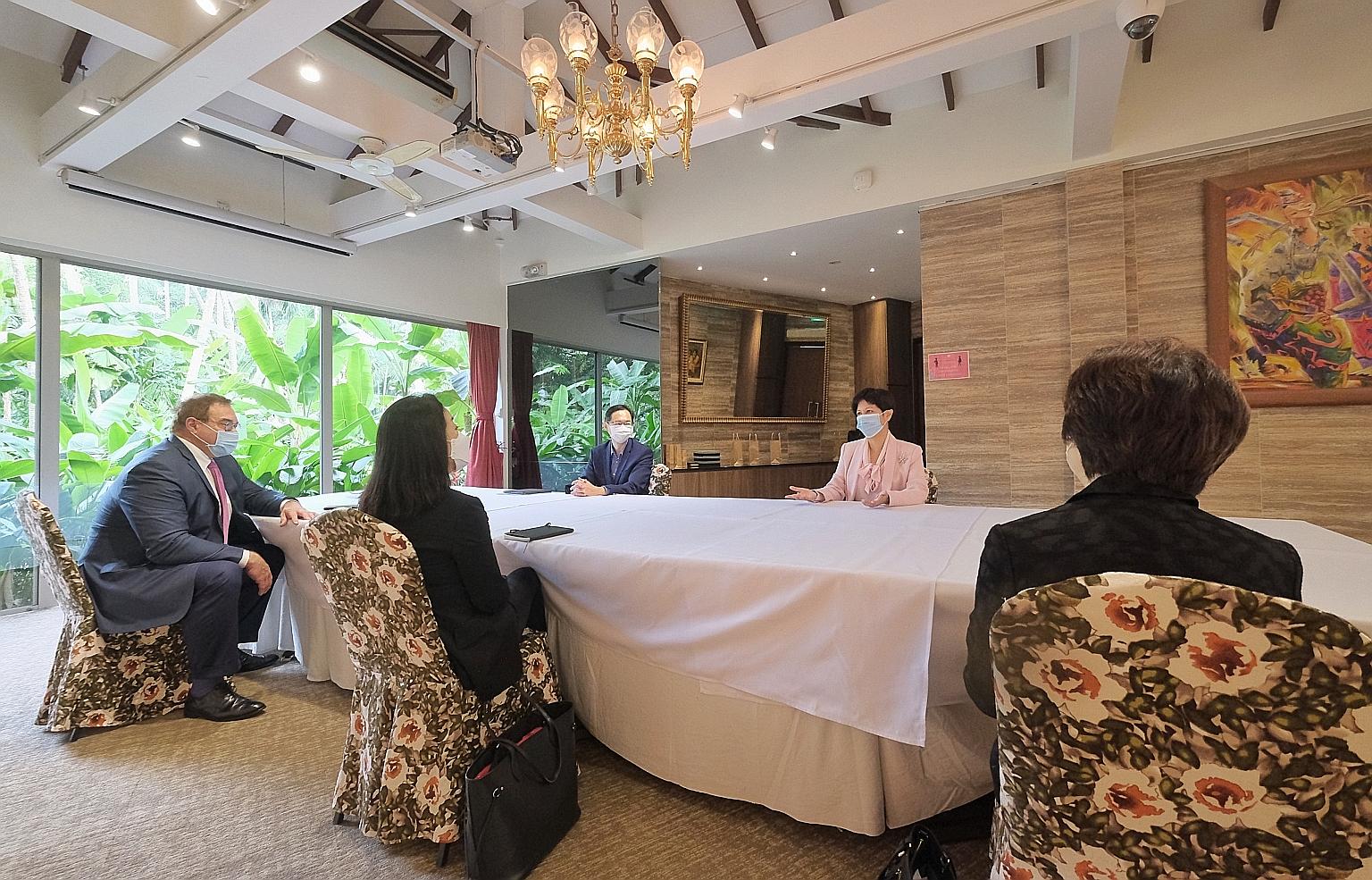 Second Minister for Finance Indranee Rajah (in pink) and Infrastructure Asia executive director Seth Tan (beside her) at yesterday's meeting at the Singapore Botanic Gardens with Asia Sustainable Infrastructure Advisory Panel members (from left) Scot