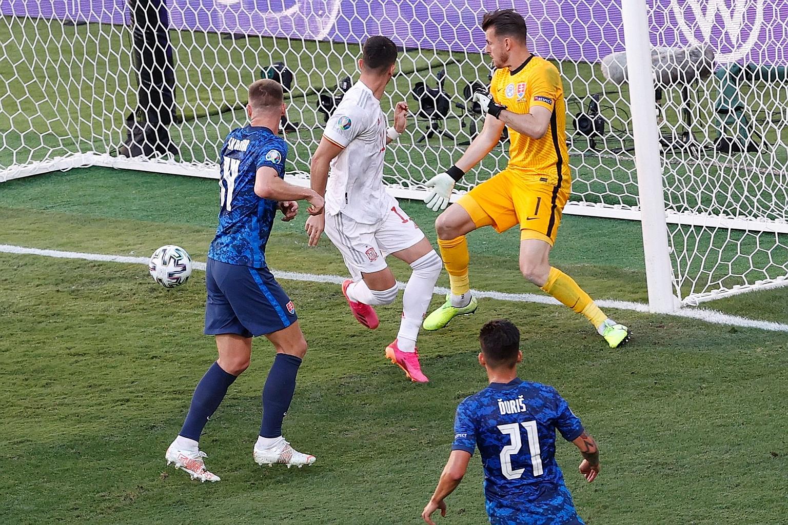 Ferran Torres (in white) scoring Spain's fourth goal with a deft back-heel during the 5-0 rout of Slovakia at the La Cartuja Stadium in Seville on Wednesday.