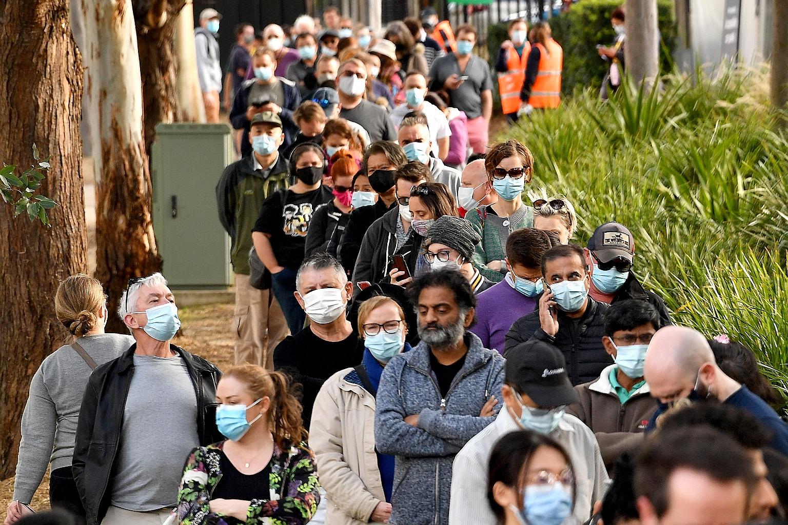 People queueing outside a vaccination centre in Sydney yesterday. Australia's New South Wales state has imposed tough restrictions in the city to contain a coronavirus outbreak in the state.