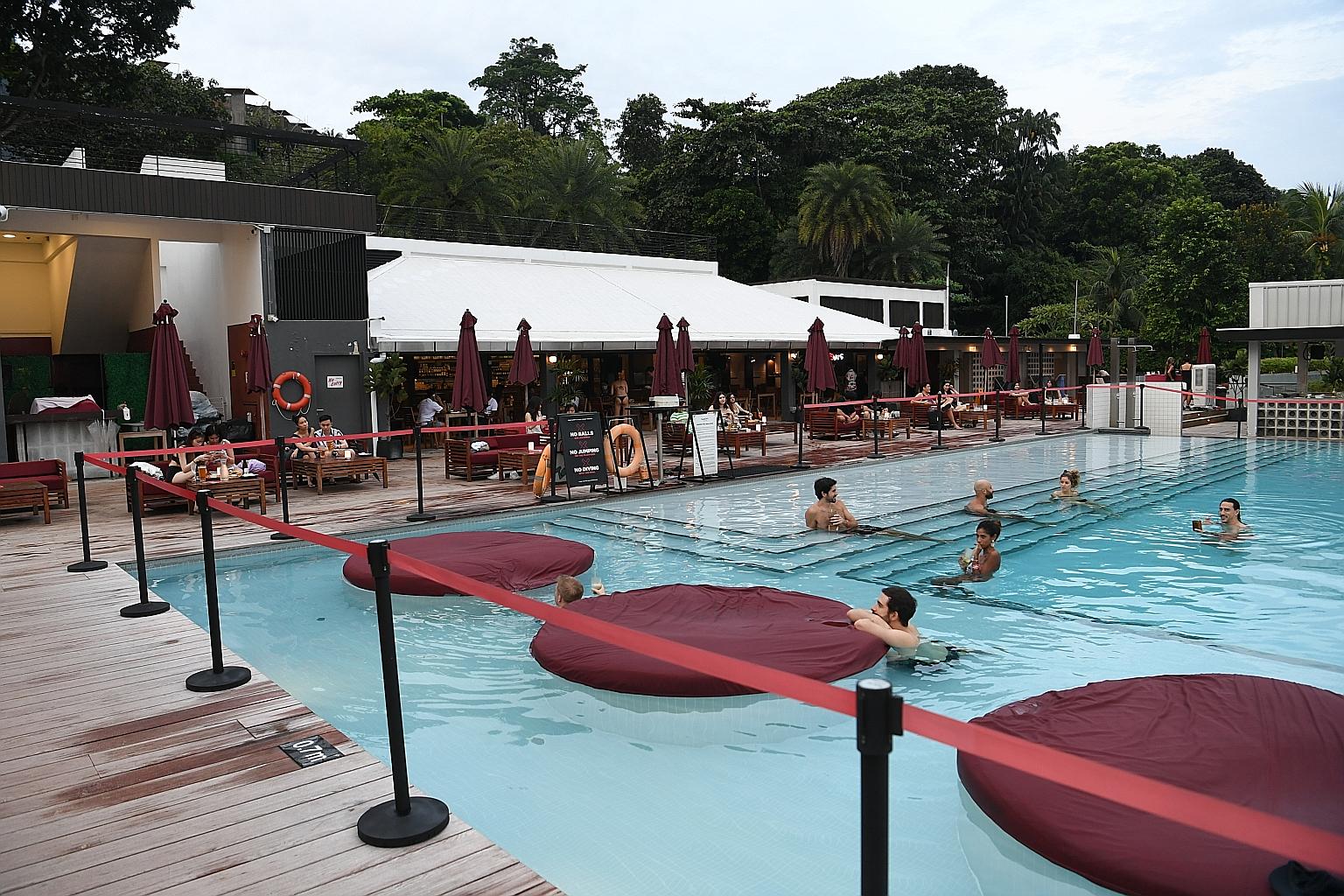 Guests at Rumours Beach Club on Sentosa Island yesterday. The club has hired a third-party security company to assist safe distancing ambassadors to make sure that patrons abide by safe management measures.