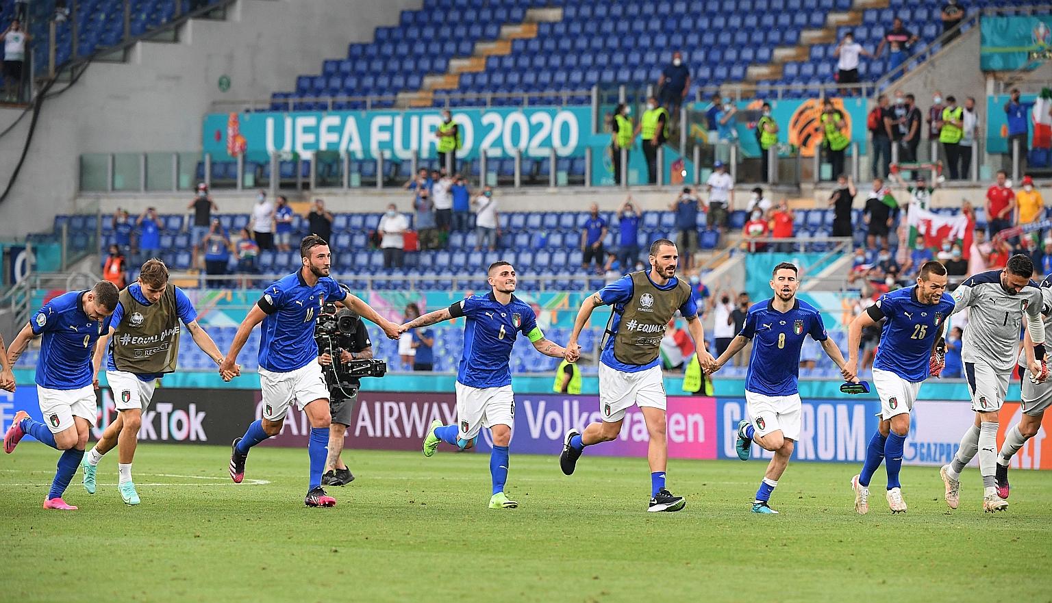 Marco Verratti (fourth from left) and teammates celebrating after beating Wales 1-0. His free kick set up Matteo Pessina for the winning goal.