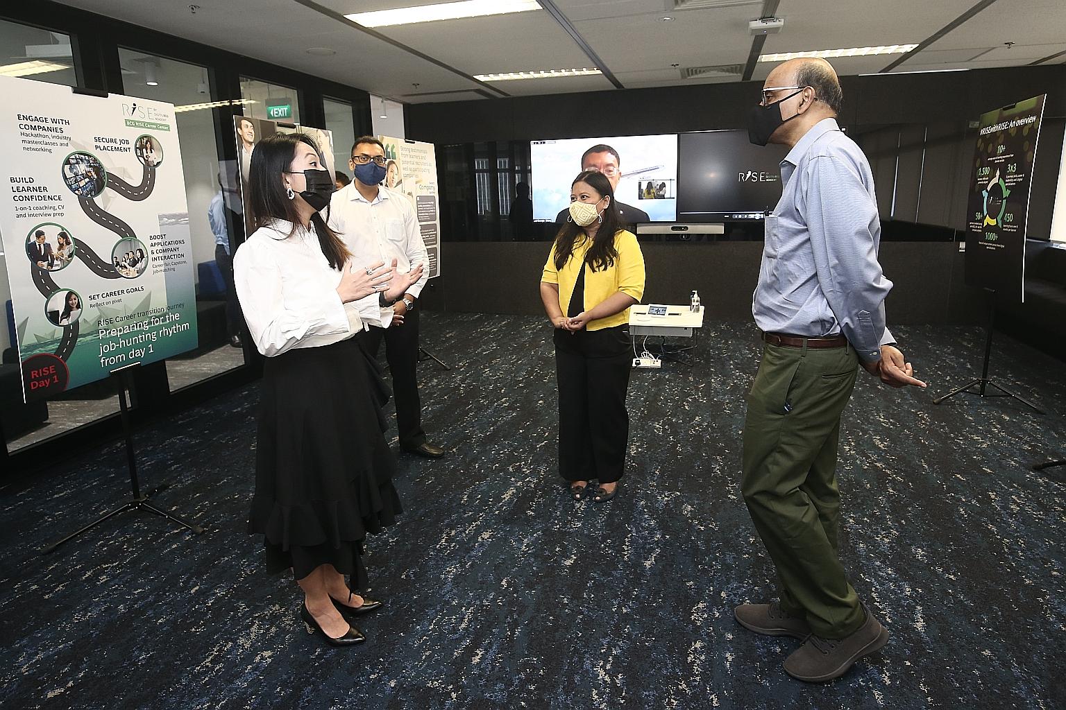 Ms Wong Ee Jin, who landed a full-time role as retail strategy director a few months into the Rise programme, speaking to Senior Minister Tharman Shanmugaratnam about her learning experience. Looking on are Boston Consulting Group partners Sagar Goel