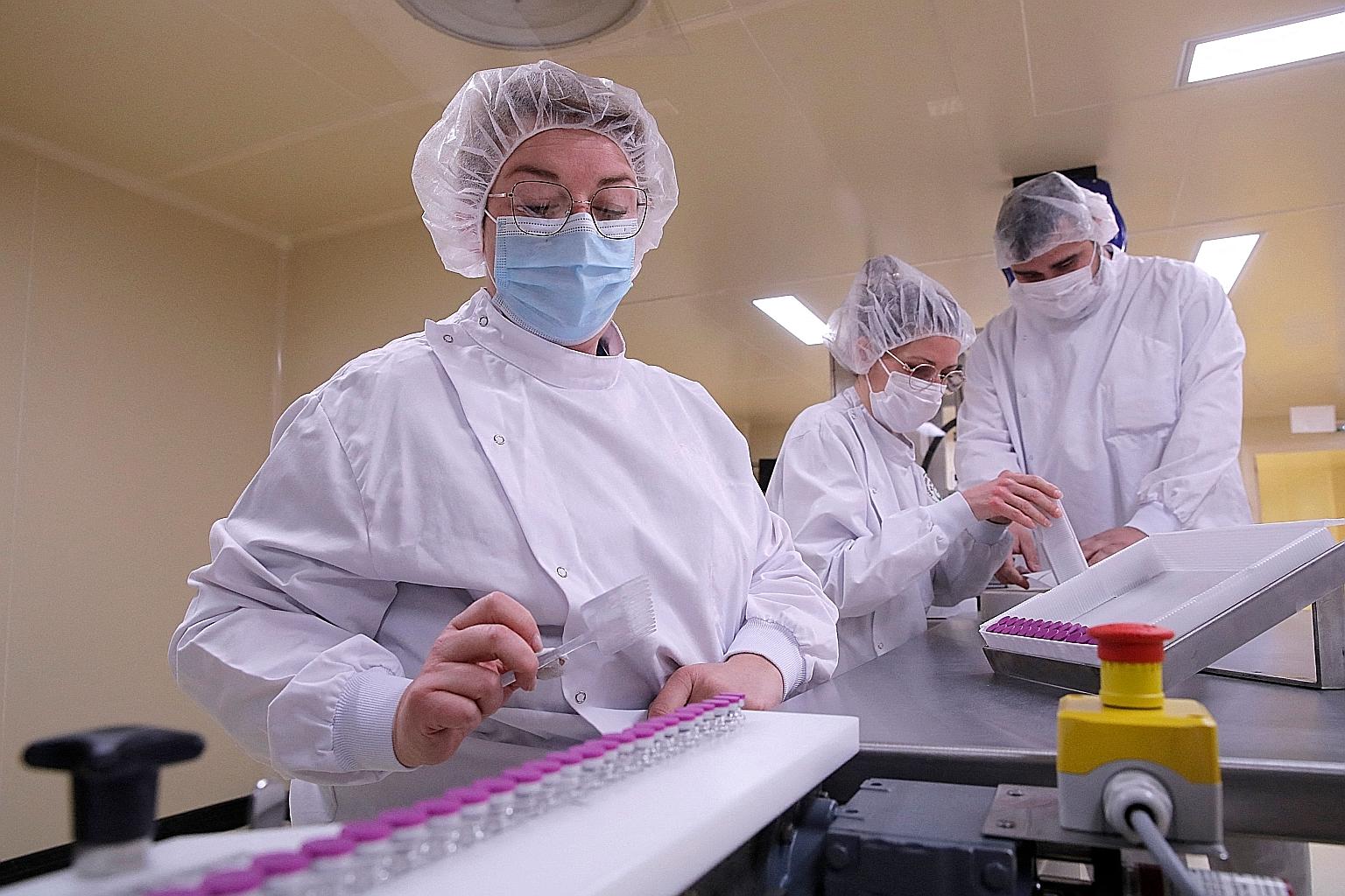 Employees at work at a plant in Saint-Remy-sur-Avre, west of Paris, where the Pfizer-BioNTech Covid-19 vaccine is bottled. A lack of fill-and-finish capacity - the final stage in which vaccines are bottled - could pose a problem for pharmaceutical fi