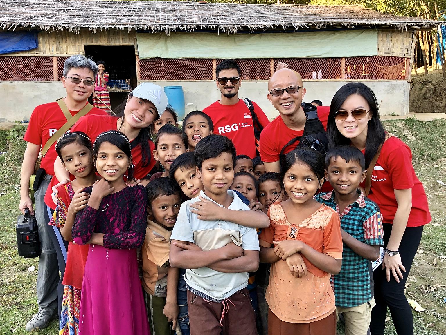 Mr Jonathan How (second from right) and other volunteers from Relief Singapore with Rohingya children in a refugee camp in Bangladesh in 2019. RSG provides humanitarian assistance and disaster relief for communities affected by conflict, calamities a
