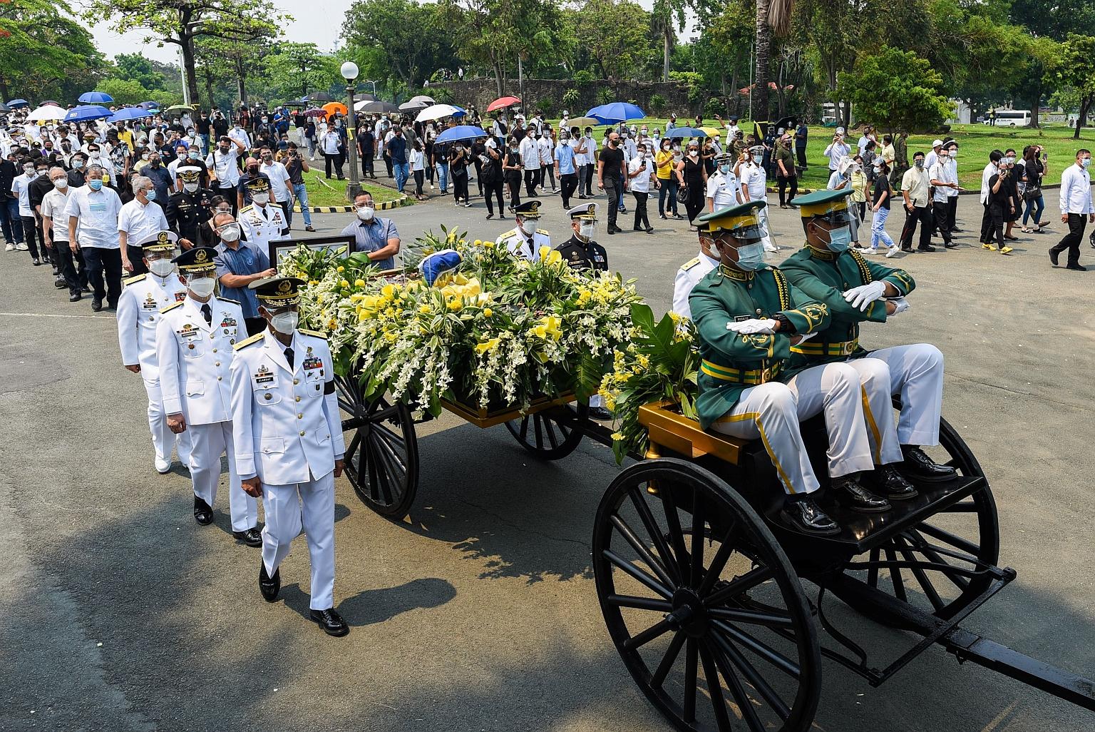 Guards of Honour with the urn holding the ashes of former Philippine president Benigno Aquino during his burial at the Manila Memorial Park yesterday. Mr Aquino served as president from 2010 to 2016, leading the Philippines through a period of prospe