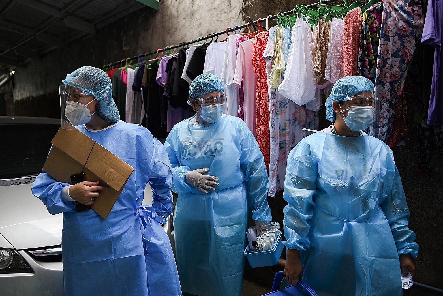 Health workers going on a house-to-house vaccination drive against Covid-19 in Manila last month. Hospitals in the Philippines are running short on nursing staff, especially with many parts of the country experiencing a worrying surge in Covid-19 inf