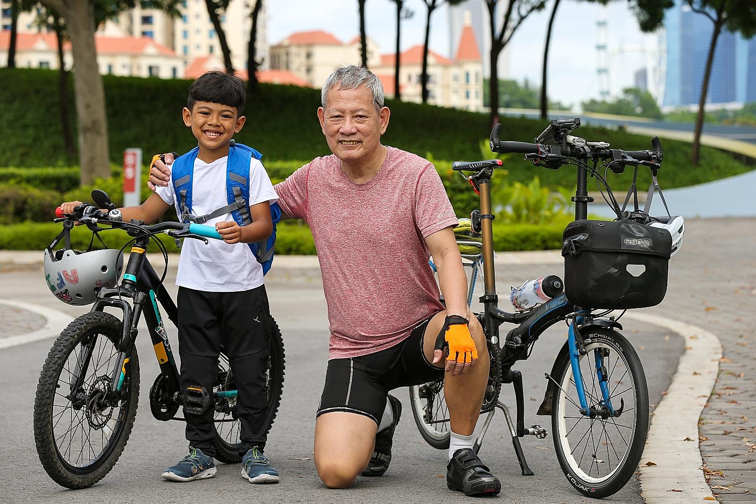 Muhammad Afi, seven, and fellow cyclist Loh Yew Kwong, 66, at Kallang. They rode from the Singapore Sports Hub to the Merlion Park and back yesterday as part of a meeting arranged by OCBC. The OCBC Cycle organiser was grateful that the duo showed tha