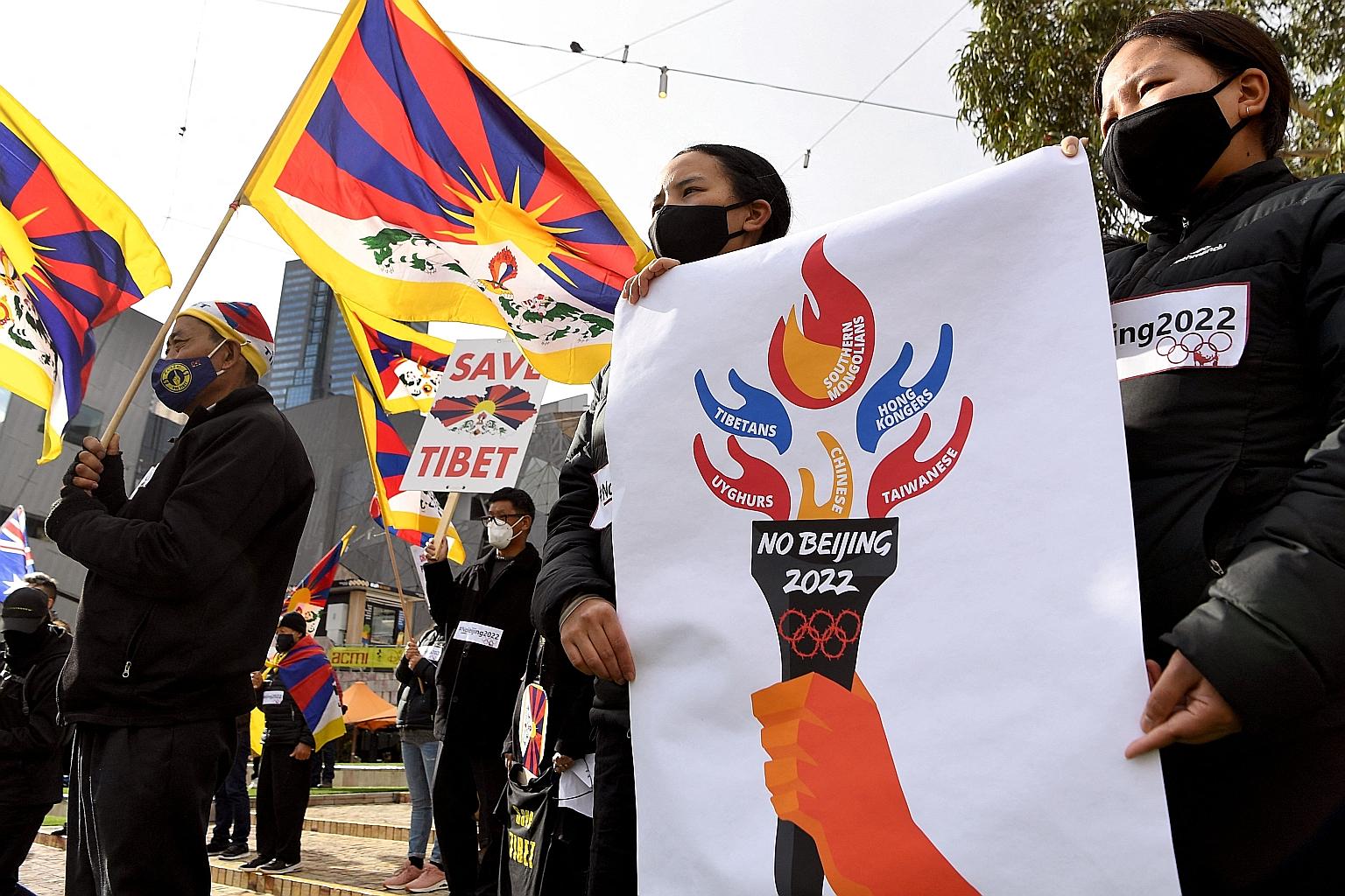 Activists, including members of the local Hong Kong, Tibetan and Uighur communities, with banners and placards in Melbourne last Wednesday, calling on the Australian government to boycott the 2022 Beijing Winter Olympics over China's human rights rec