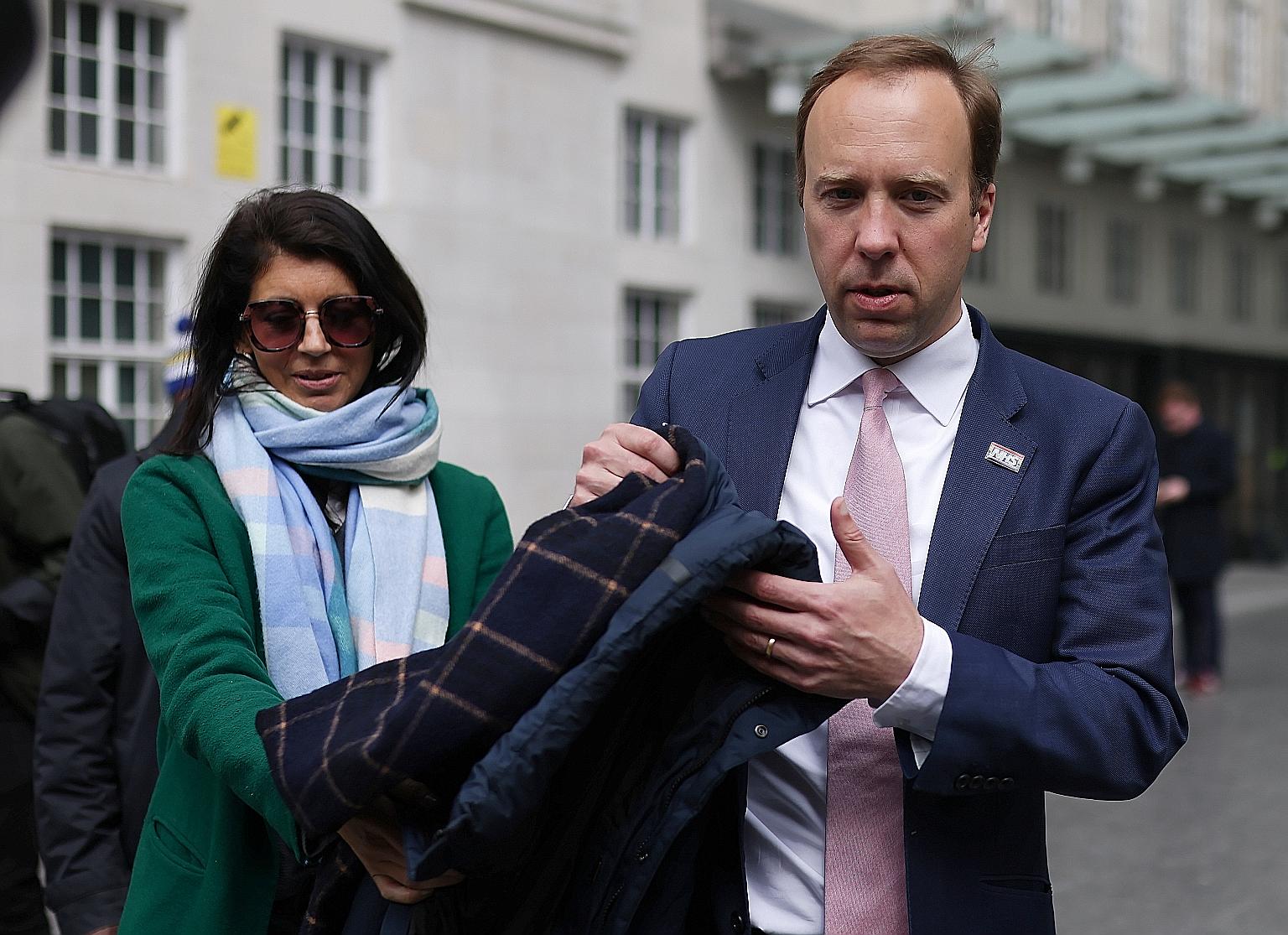 Former British Health Secretary Matt Hancock with his aide Gina Coladangelo outside BBC's Broadcasting House in London last month. He was forced to resign after he was spotted embracing and kissing her in his office last week.