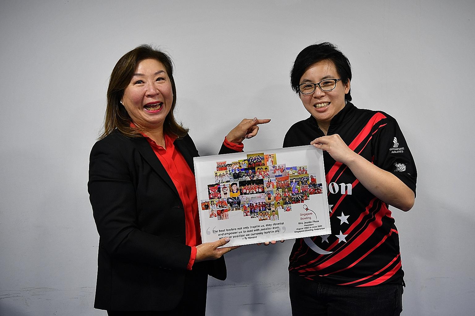 Singapore Bowling Federation president Jessie Phua (far left) receiving a memento from Valerie Teo at the association's AGM yesterday. Teo, a former national bowler, will take over as SBF president.