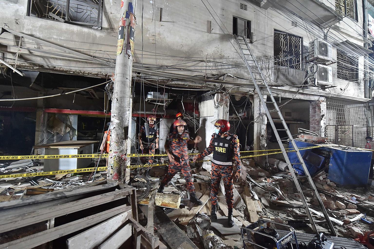 Firefighters inspecting the scene where the suspected gas explosion in Bangladeshi capital Dhaka took place on Sunday. Police said at least two adjacent buildings were also partially damaged.