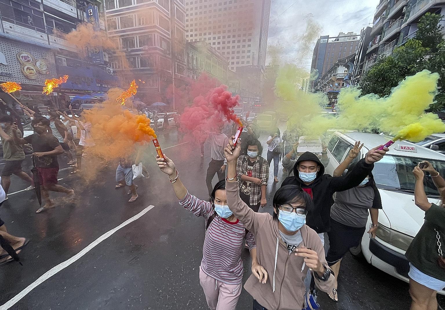 Demonstrators holding flaming torches and flares as they protested in Yangon last Saturday against Myanmar's military coup. Over 870 people have been killed by security forces and more than 6,000 detained since the Feb 1 coup, said the Assistance Ass