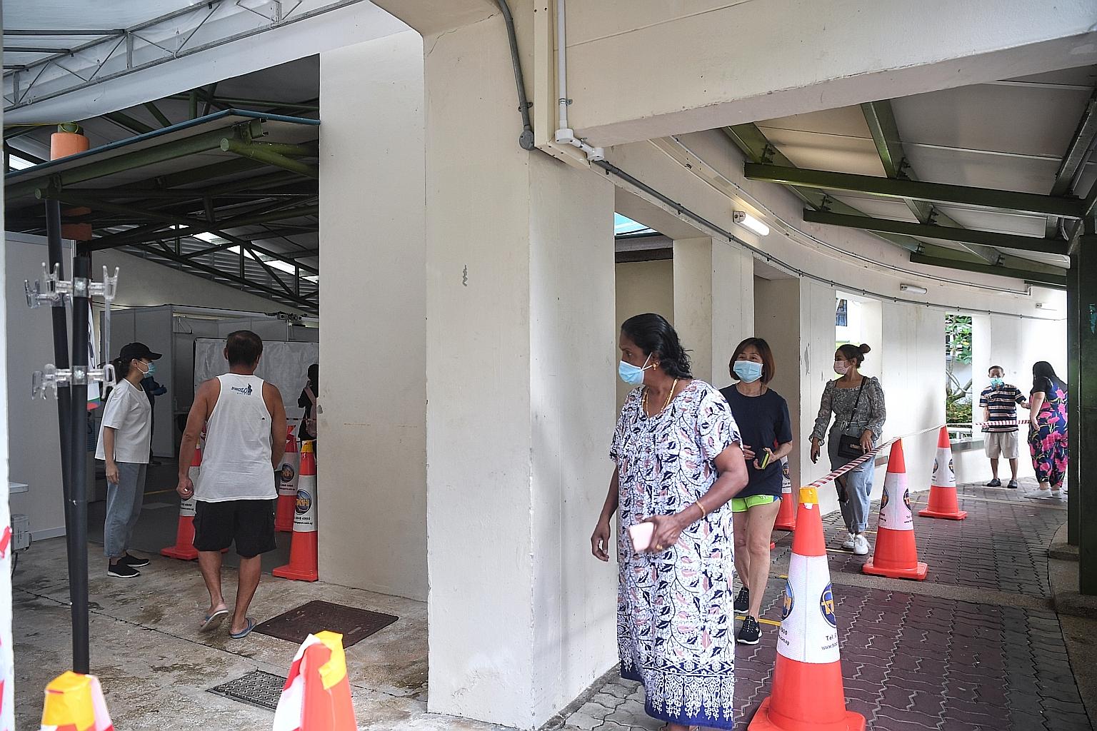 Residents of Block 103 Henderson Crescent going for mandatory Covid-19 testing on Monday, amid several rounds of mass testing at various Housing Board blocks in the Bukit Merah and Redhill area.