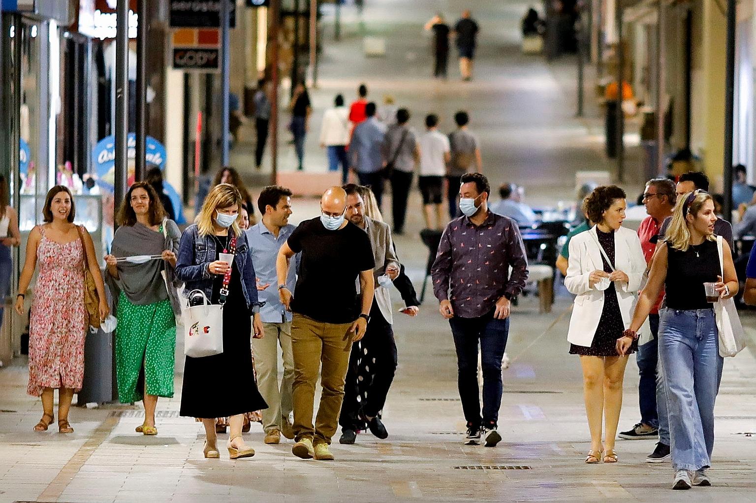 People out on the streets unmasked in Ronda in southern Spain last Saturday, after the government eased rules on wearing masks outdoors. PHOTO: REUTERS