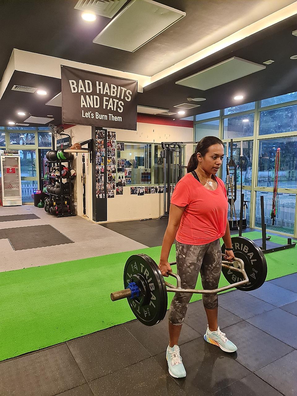 Managing director Penny Lau (left), with personal trainer Kenneth Seow, at Level Gym in the Central Business District. Since June 21, indoor, mask-off sports and exercise activities have been allowed to resume in groups of two people. Ms Rehkha Chand