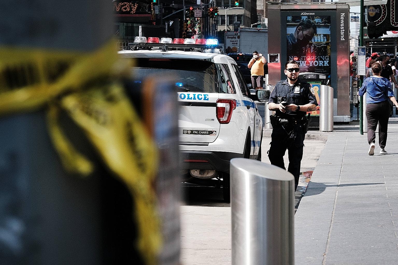 A police officer in New York City's Times Square on Monday, following another daytime shooting in the popular tourist destination the day before. The rise in gun violence this year has cast a shadow on the city's reopening after 15 months of Covid-19