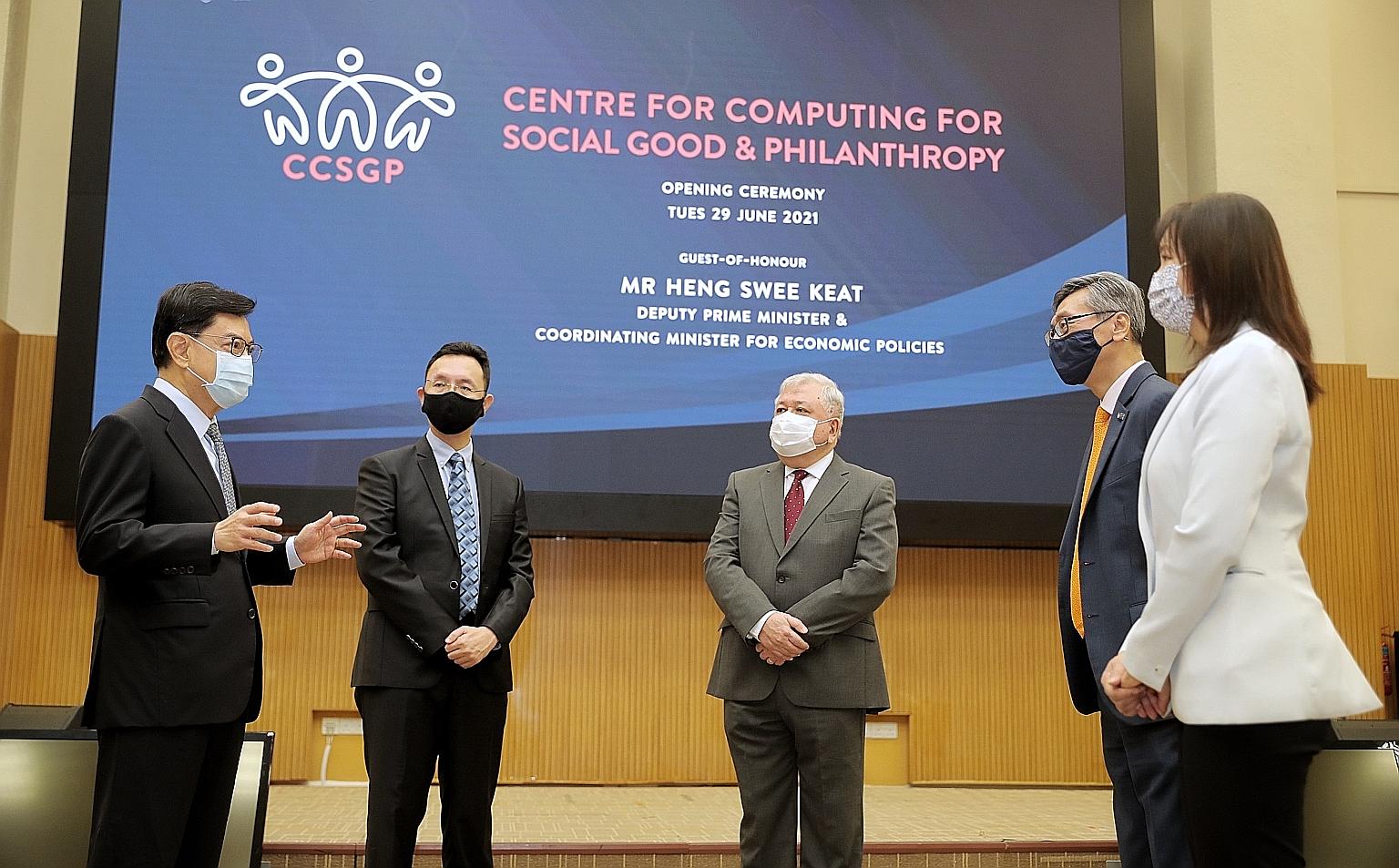 Deputy Prime Minister Heng Swee Keat at the launch of the Centre for Computing for Social Good and Philanthropy at the National University of Singapore (NUS) yesterday, with (from second from far left) Associate Professor Ben Leong, director of the c