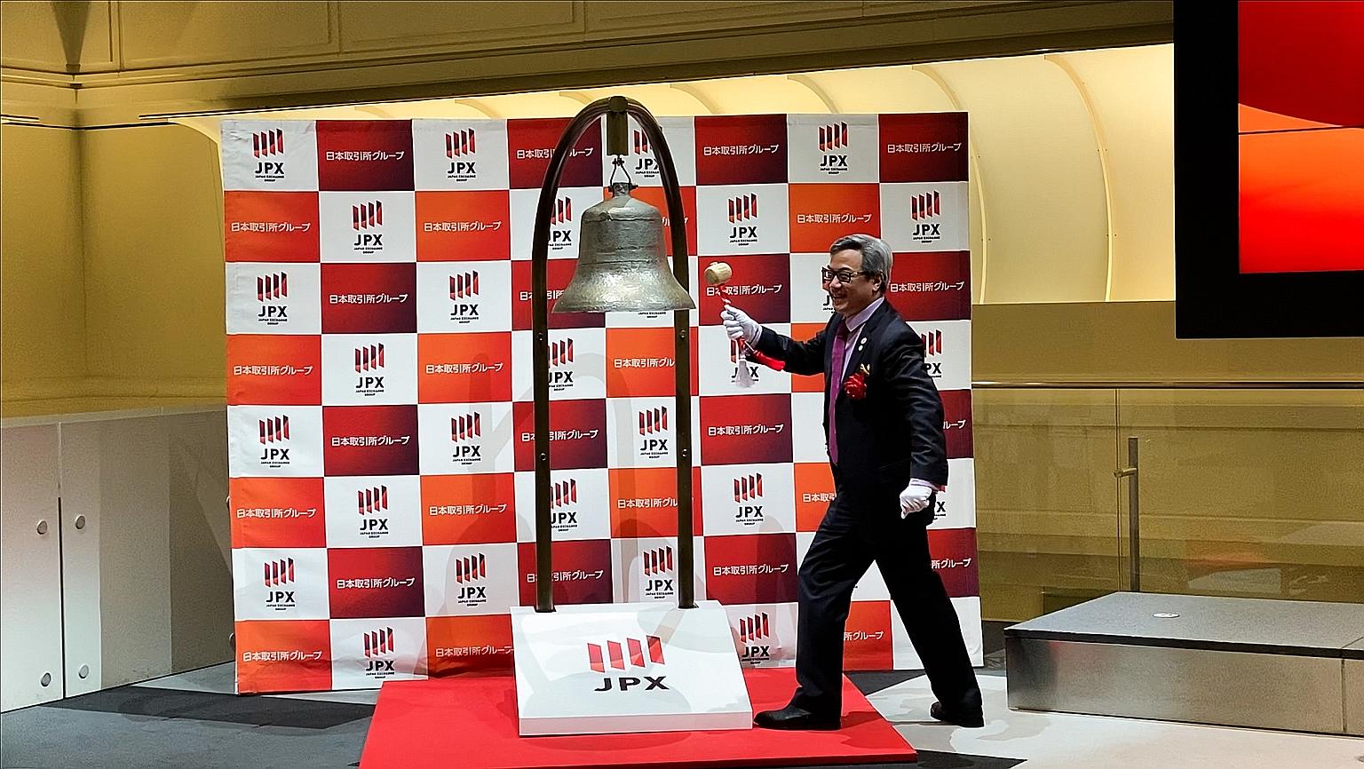 Omni-Plus System chief executive Marcus Neo Puay Keong sounding a bell at the listing ceremony at the Tokyo Stock Exchange yesterday.