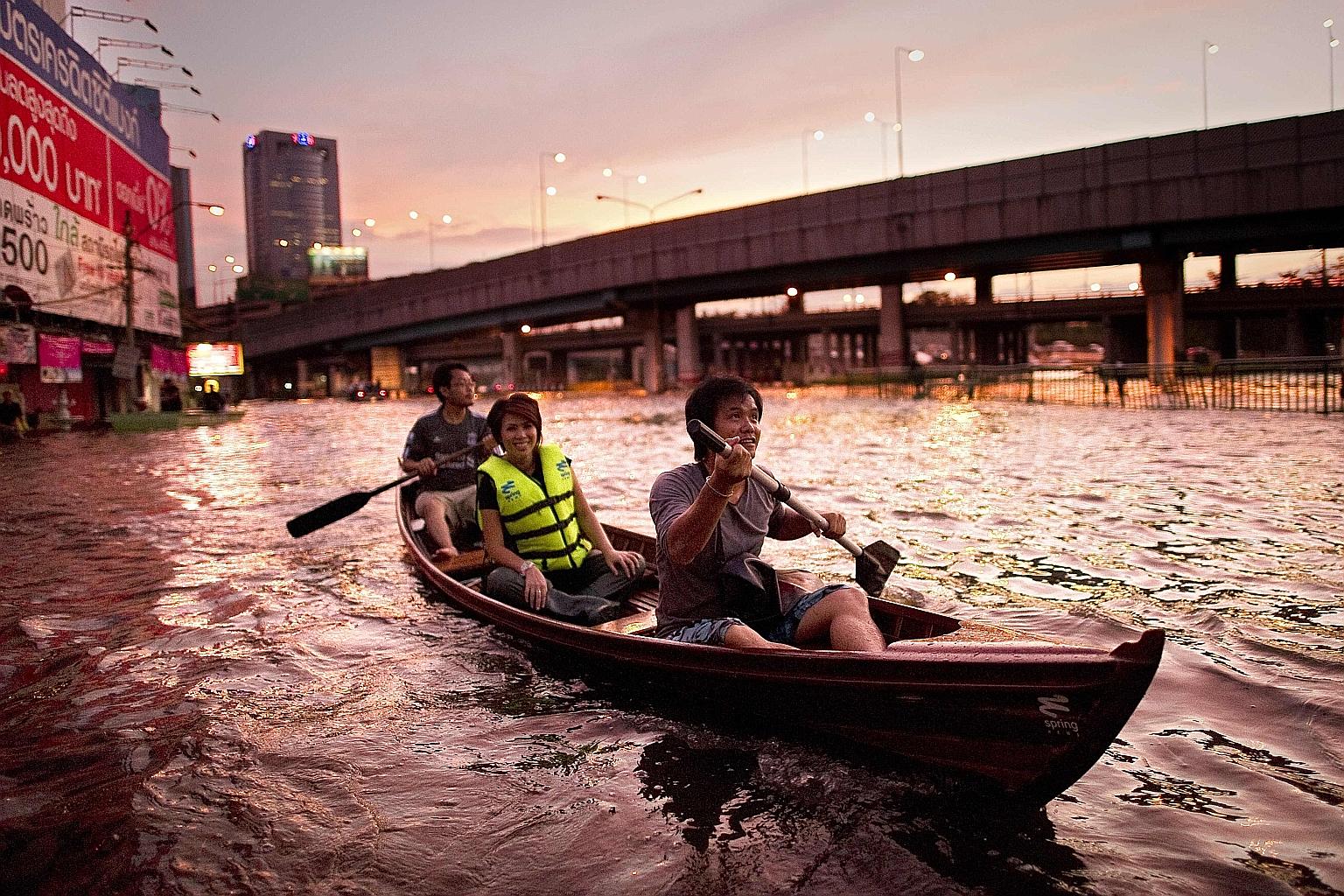 Residents using a boat to cross floodwaters in Bangkok in 2011. The global average sea level is rising at more than 3mm per year. For some Asian regions, the sea level rise is exacerbated by land subsidence, as major cities including Bangkok pull wat