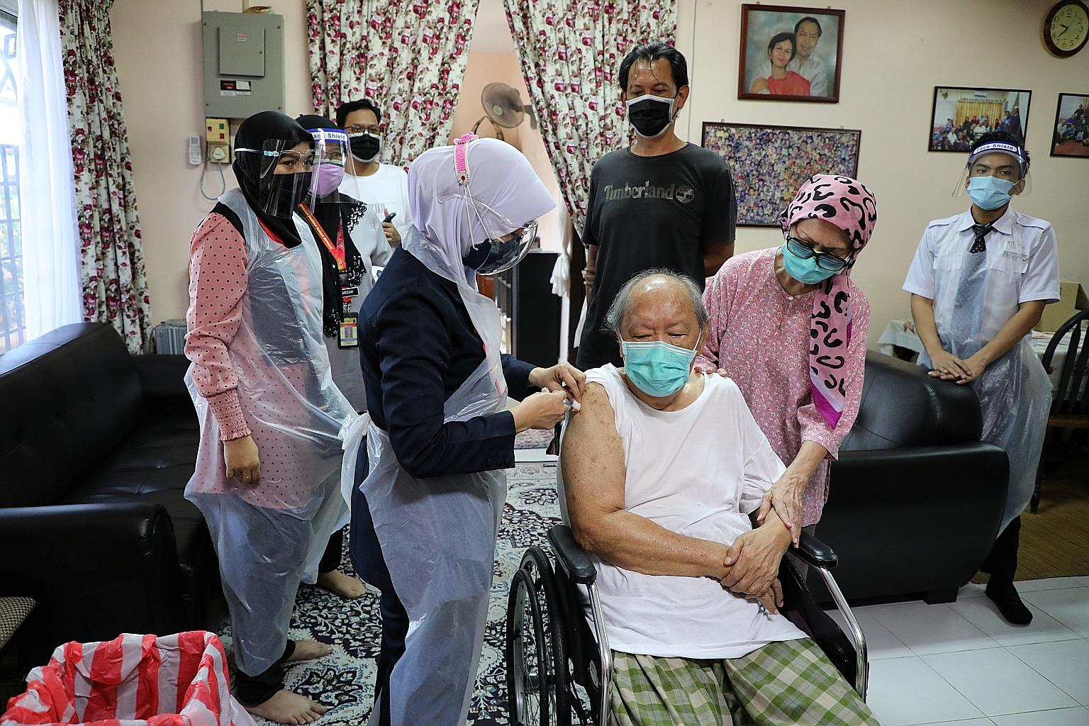 A healthcare worker giving Mr Mohd Yusof Abdul Hamid, 77, a shot of the Sinovac vaccine at his home in Sabak Bernam, in Selangor. Only 7.2 per cent of the population have been fully inoculated as at Wednesday.