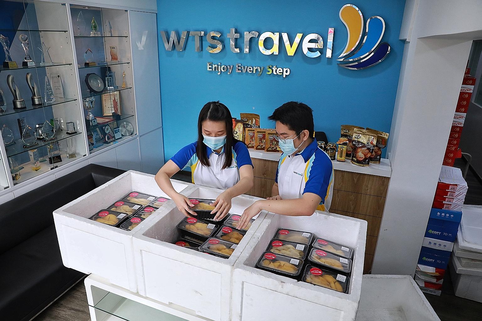 WTS Travel staff packing durians according to delivery orders. WTS Travel has been selling speciality food items, like durians, on its e-commerce platform PinGo since last June. ST PHOTO: KEVIN LIM