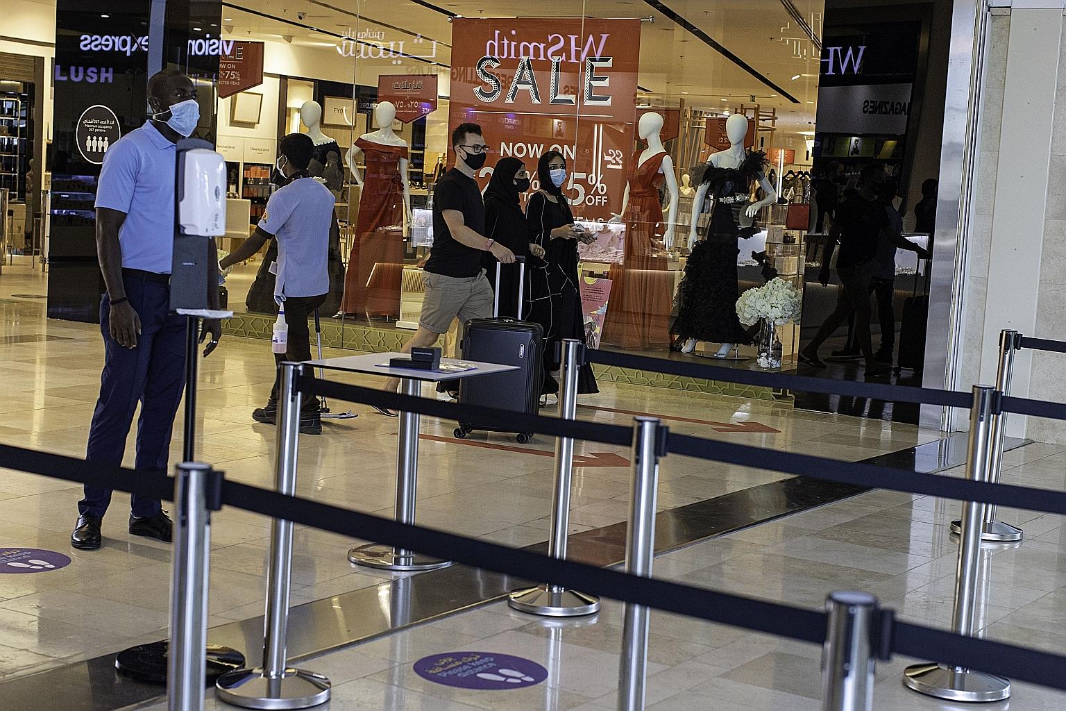 A security officer on the alert to ensure people follow social distancing measures at the entrance to Yas Mall in Abu Dhabi last Thursday. Daily infections in the United Arab Emirates have hovered around 2,000 since March, from a peak of about 4,000 