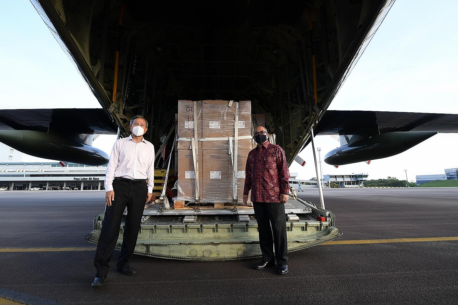 Minister for Foreign Affairs Vivian Balakrishnan (left) and Ambassador of the Republic of Indonesia to Singapore Suryo Pratomo at Paya Lebar Air Base yesterday during a ceremony to hand over the supplies. Items sent on the Republic of Singapore Air F