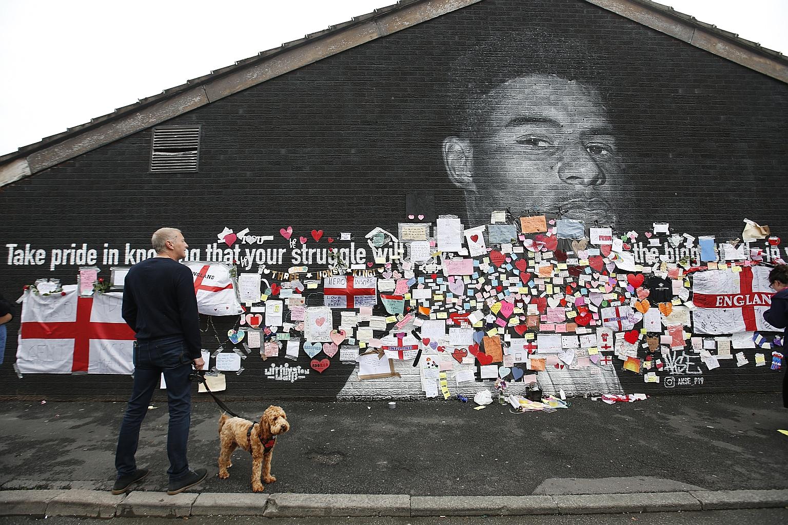The mural honouring England's Marcus Rashford in his home town of Withington was defaced with hateful language before it was covered with messages of support from the locals.