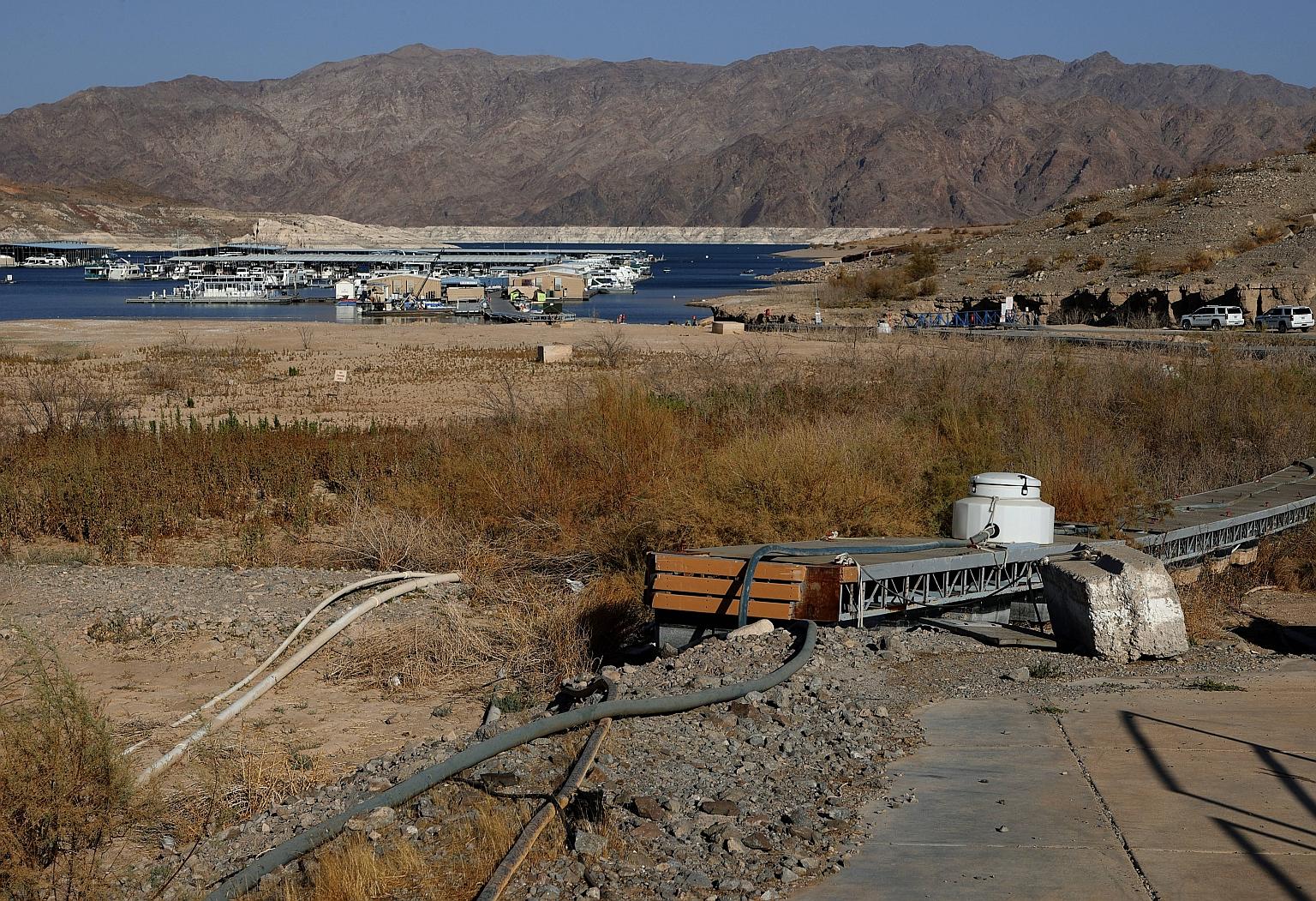 Boats moored in the distance behind a defunct bridge that once led visitors to the Callville Bay Marina in the Lake Mead National Recreation Area, Nevada. The proposed bipartisan infrastructure deal would pay for rebuilding roads, bridges and other t