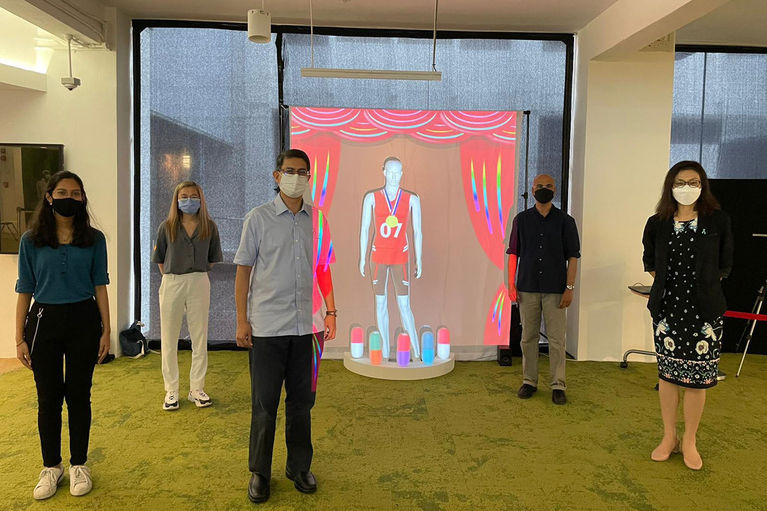 Minister of State Muhammad Faishal Ibrahim (centre) standing in front of the art installation, Monomania, with (from left) Ms Lumna Chitrakar and Ms Crystel Chia Qi Hui, Singapore Polytechnic's (SP) School of Media, Arts and Design senior lecturer Ch