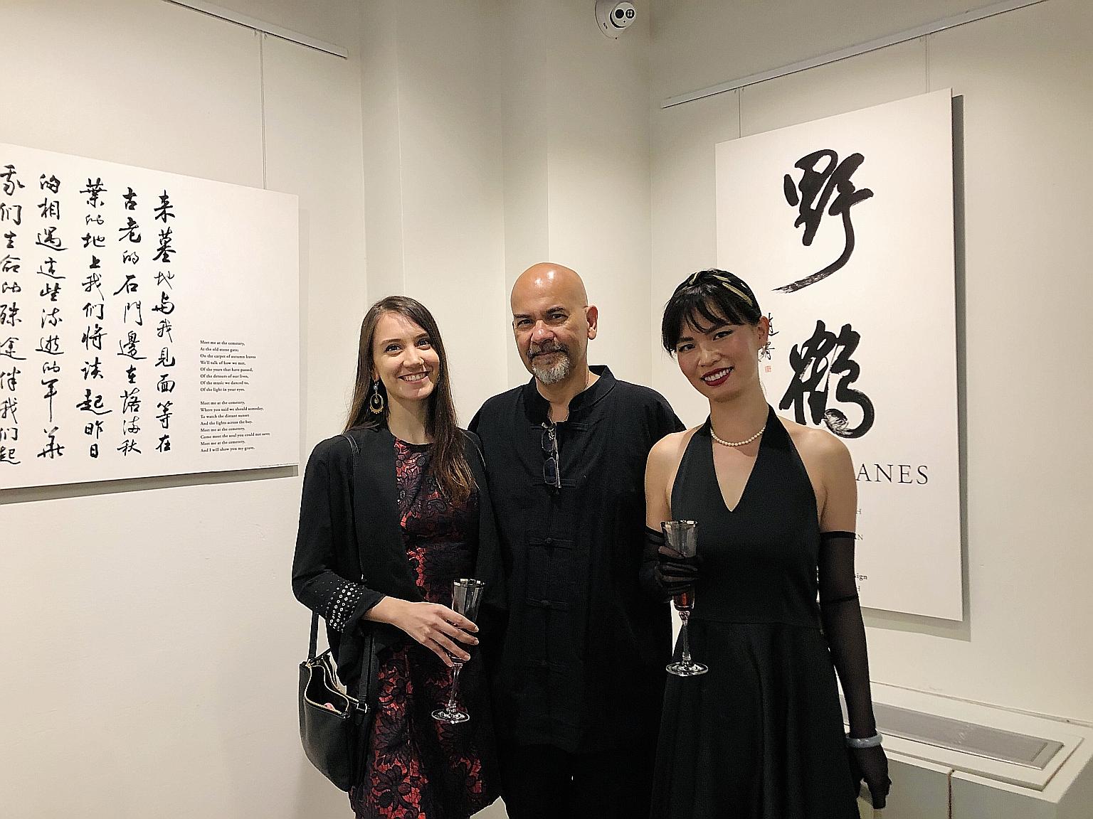 Mr Nirmal Ghosh with translator Liuyu Ivy Chen (left) and his daughter Tanya Ghosh (far left), who laid out and designed the displays, at the Wild Cranes exhibition in Washington DC's Chinese American Museum.