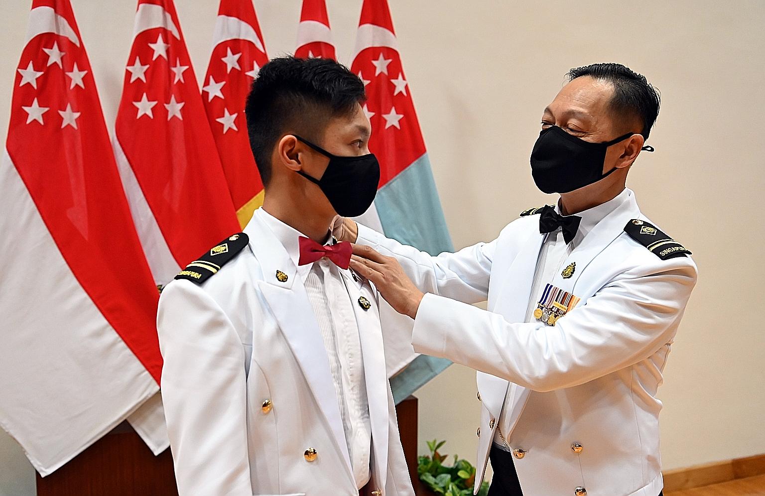 ME4 Roy Tan (far left) and his father, ME4 Tan Gim Cheong. When he decided to sign up in 2017, ME4 Roy Tan's father was quick to offer advice. Said the elder ME4 Tan, a senior Republic of Singapore Navy instructor: "When at home, we'd share with each
