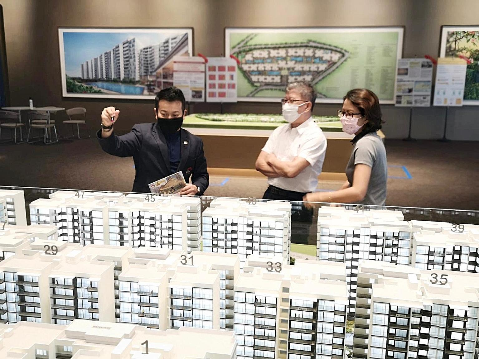 Visitors looking at a model of Treasure at Tampines, which was among the best-selling private home projects for last month. Developers sold 872 units in June, down 2.6 per cent from 895 units in May, according to the Urban Redevelopment Authority yes