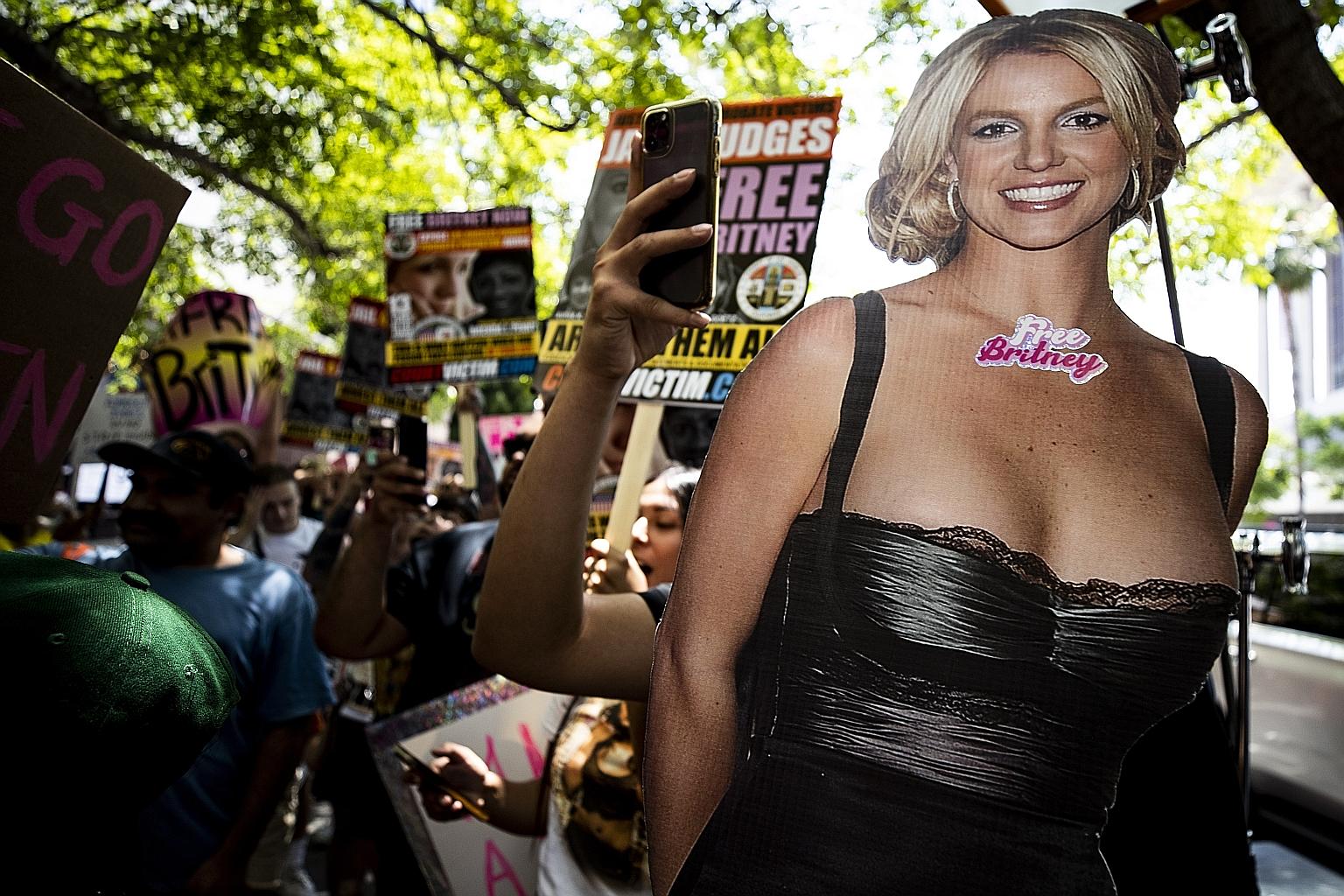 Director Spike Lee and his wife at Cannes this week. A demonstrator holding a Britney Spears cardboard cutout during a #FreeBritney protest at the Los Angeles courthouse where the singer's conservatorship hearing is held.