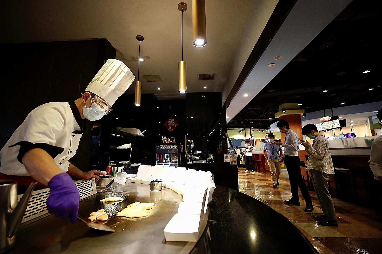 A restaurant cook in Taipei preparing takeaway food. Most restaurants and stores will not see their sales recover to around half of their pre-coronavirus outbreak levels until the Taiwan government fully lifts its restrictions. The government's so-ca