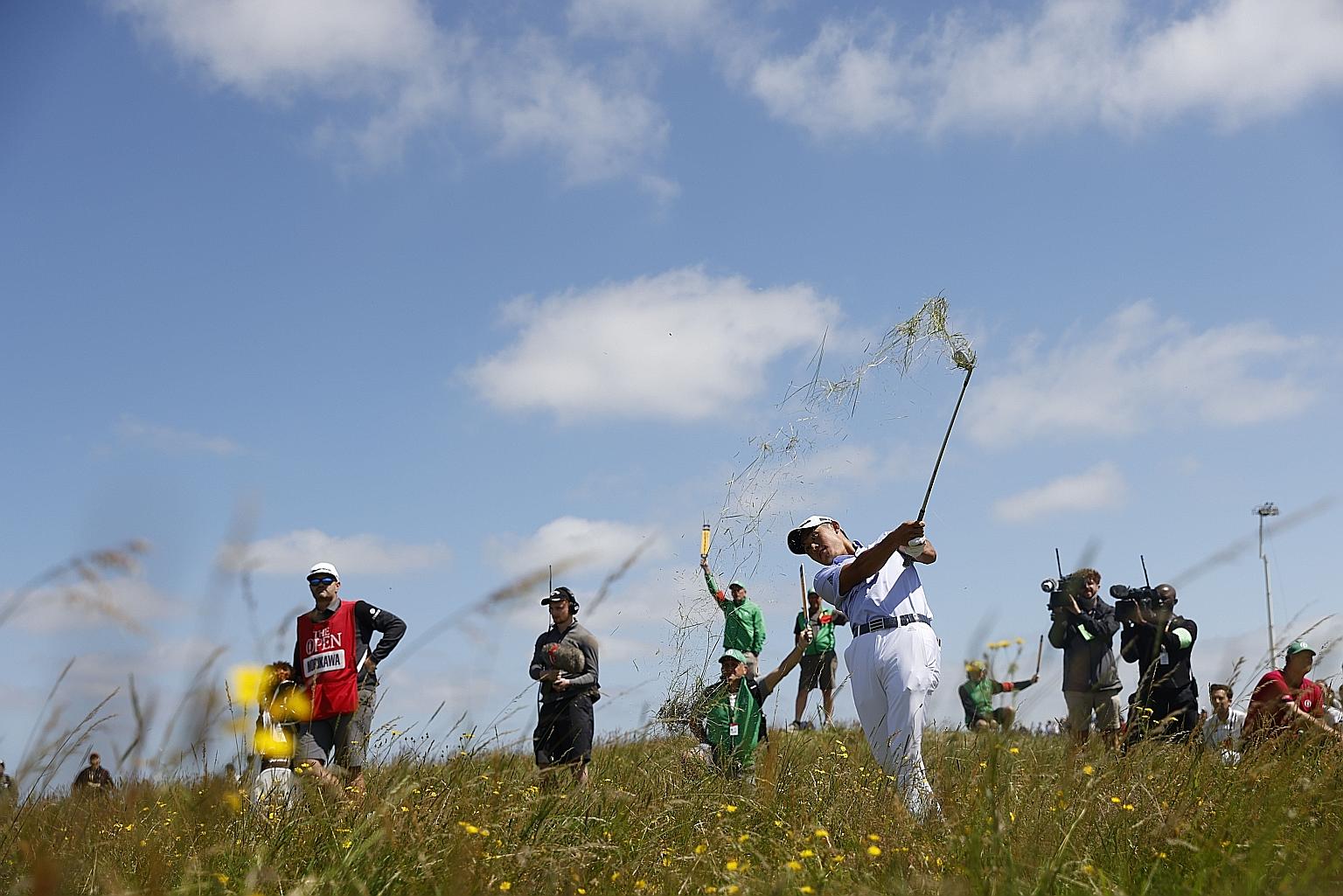American Collin Morikawa, who won his first Major title at last year's PGA Championship, blasting out of the rough in the second round of the British Open at Royal St George's yesterday. He had a six-under 64.