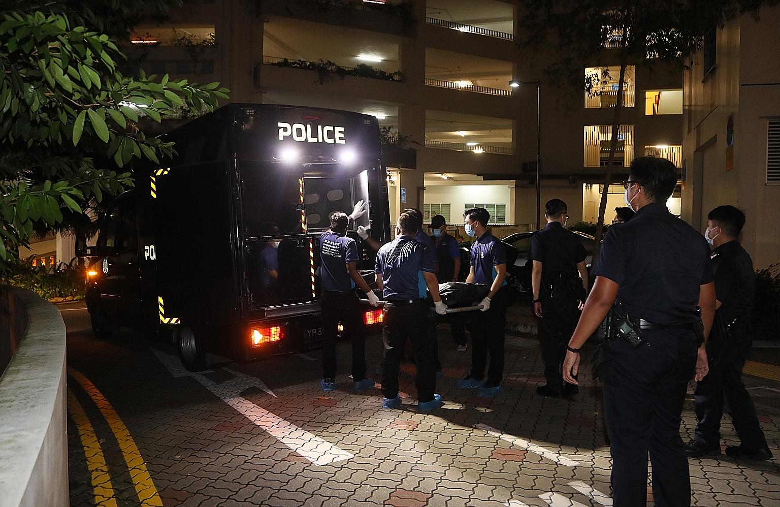 The body of a 46-year-old being removed after he was found fatally stabbed along a corridor outside a flat on the sixth storey at Block 326A Sumang Walk near Punggol Central on Wednesday. PHOTO: LIANHE ZAOBAO