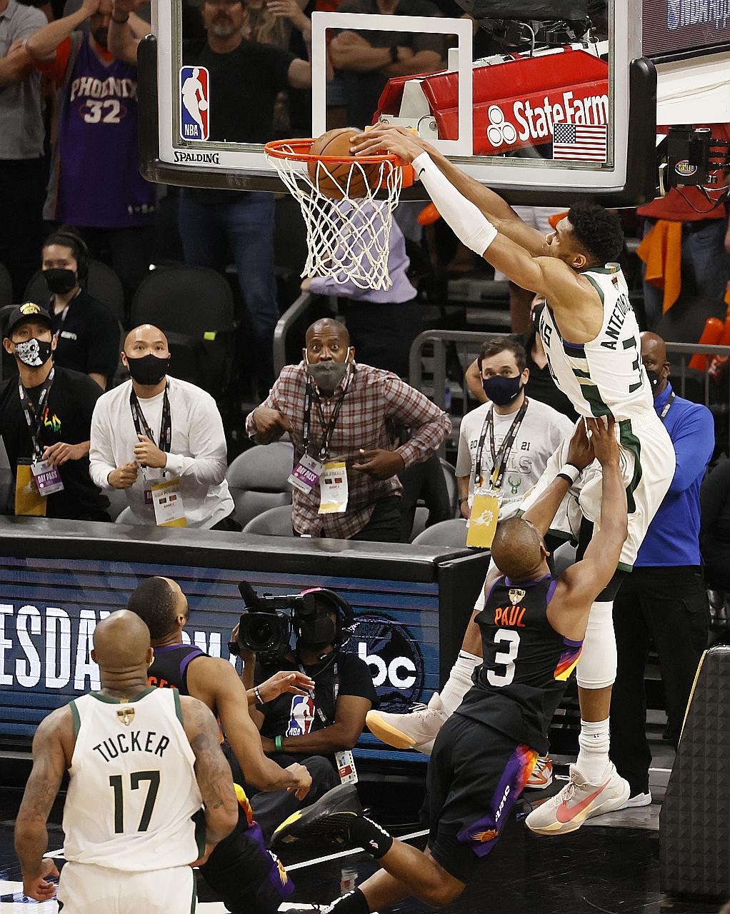 Jrue Holiday steals the ball from Phoenix Suns' Devin Booker and makes an alley-oop pass to Giannis Antetokounmpo for a slam dunk, giving the Milwaukee Bucks a 3-2 edge in the best-of-seven NBA Finals.