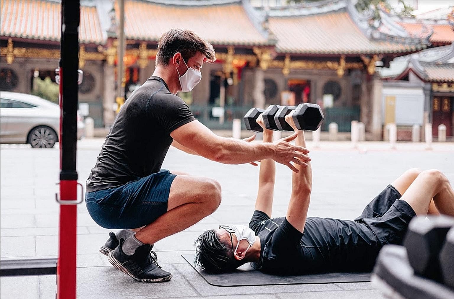 A fitness coach from Level Gym conducting a one-to-one training session. From tomorrow, mask-on activities can be conducted in groups of no more than two people, in classes of up to 30. PHOTO: LEVEL SINGAPORE