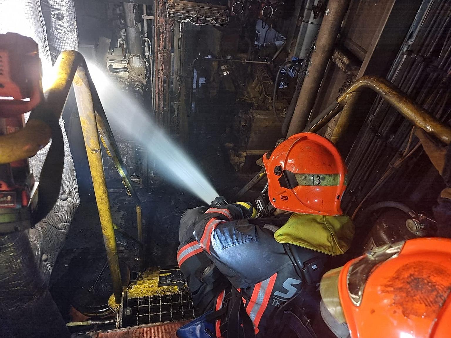 Firefighters from the Singapore Civil Defence Force putting out a blaze that broke out on a tugboat berthed in West Coast on Tuesday afternoon. PHOTO: SINGAPORE CIVIL DEFENCE FORCE/FACEBOOK