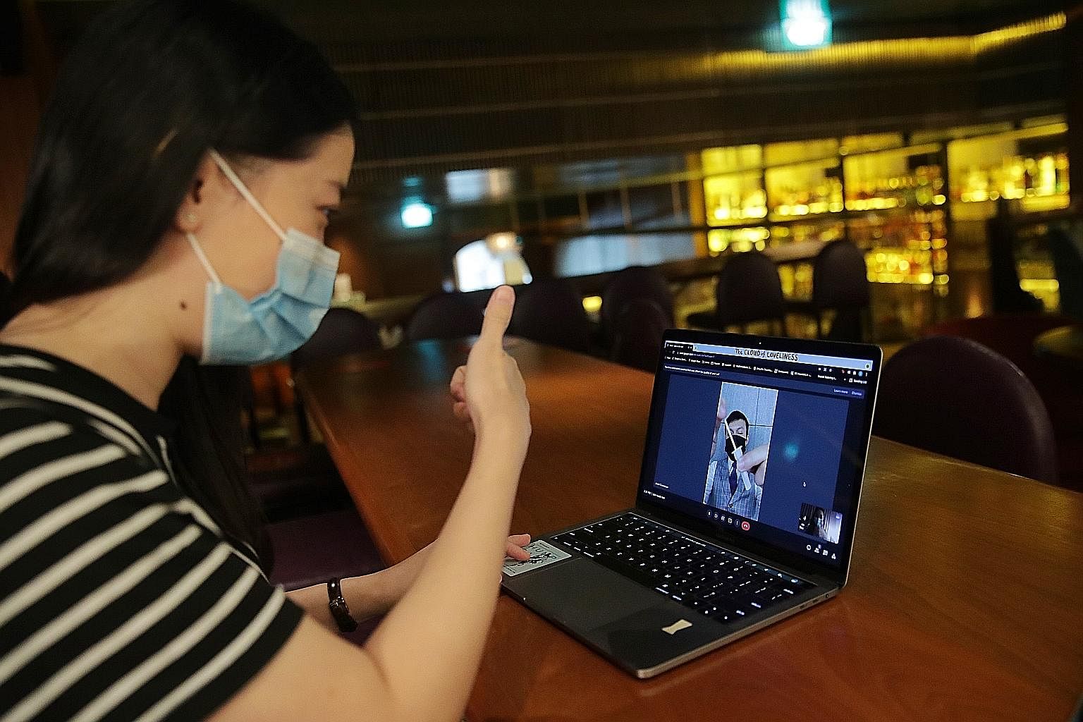 Left: Ms Cheah Lai Ee from Jigger & Pony Group supervising Mr Conceicao from another location as he uses the self-testing kit. The group's staff do their tests during live video calls or on-site with supervisors to ensure everyone has a negative resu