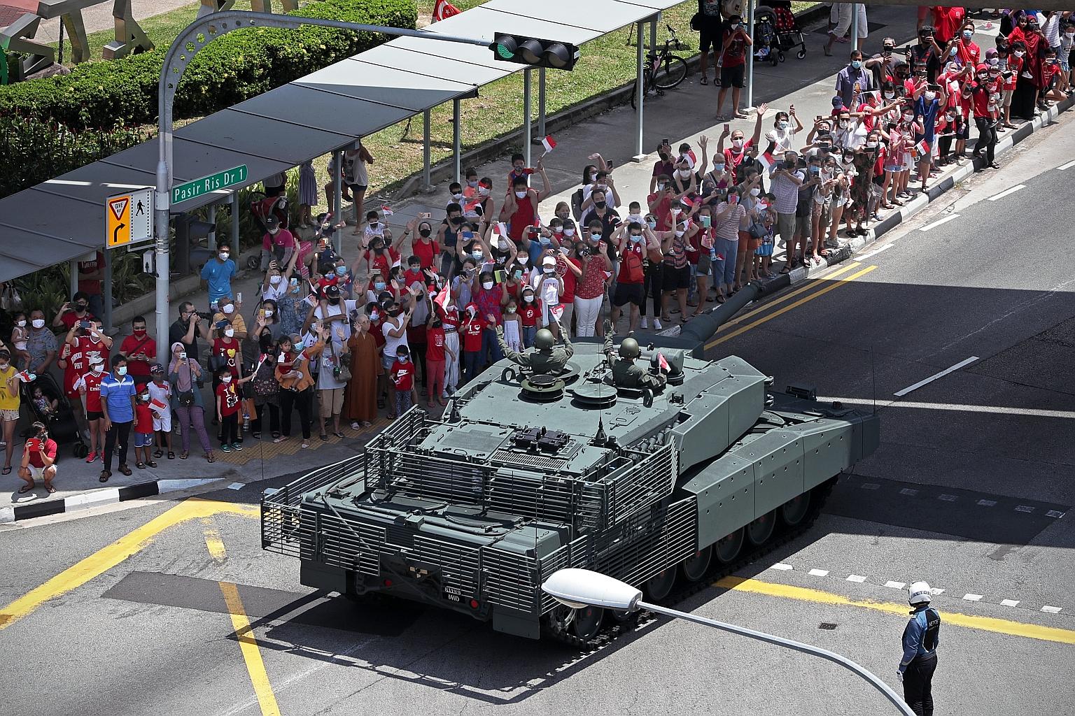 Spectators gathered in Pasir Ris to watch the mobile column as it travelled through heartland areas on Aug 9 last year. To mark National Day this year, heartland fireworks and the Red Lions' free-fall jumps were to take place on Aug 7 and 8, but thes