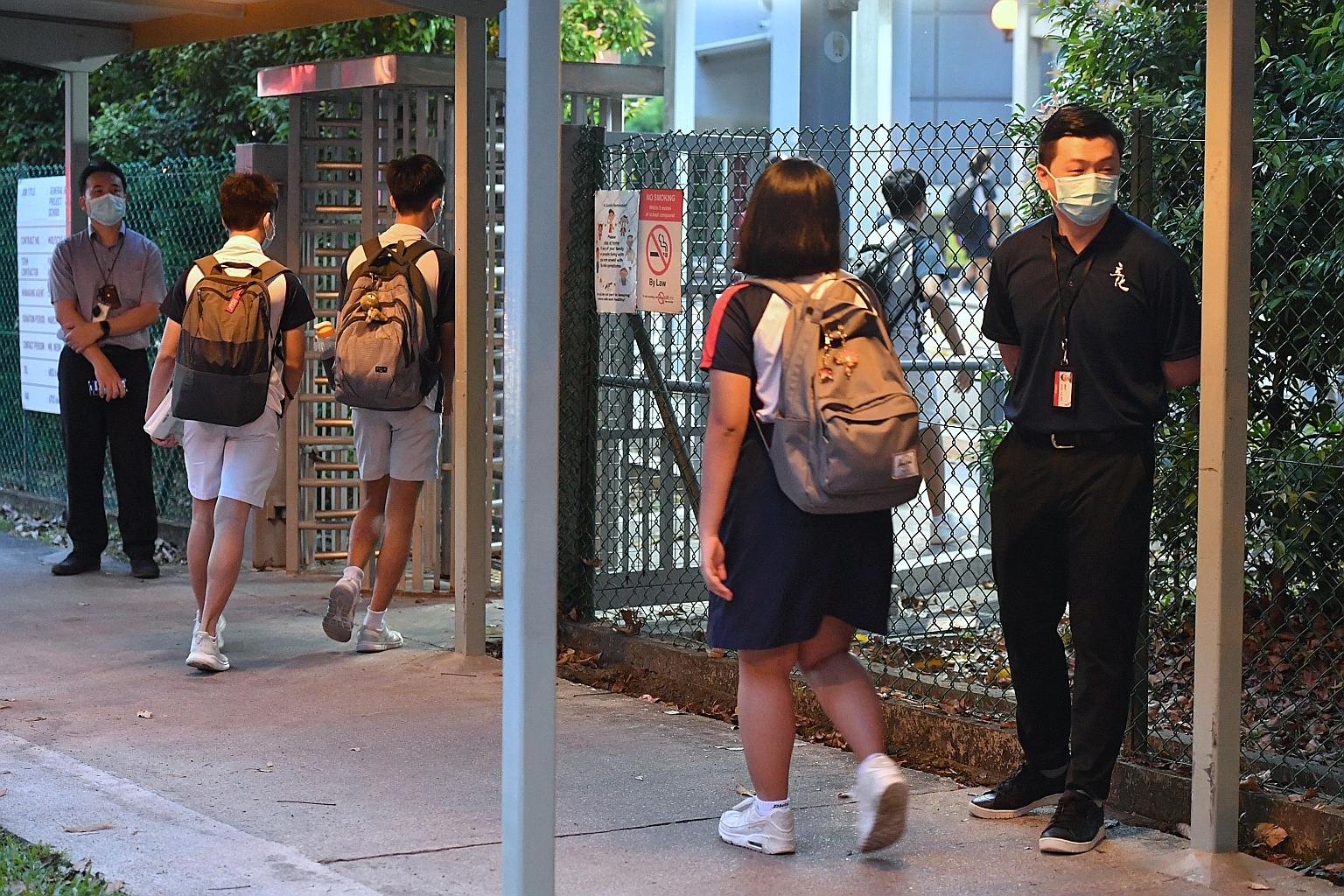 River Valley High School staff waiting outside the grounds as students returned to the school on Wednesday, after a public holiday on Tuesday. An alleged murder at the school on Monday has shaken the nation.