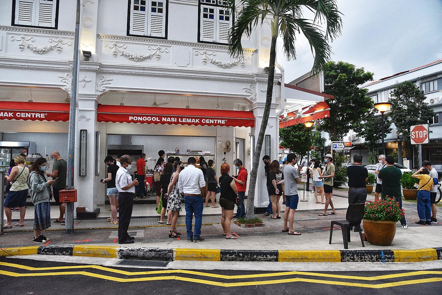 Patrons observing safe distancing while queueing outside a food outlet in Tanjong Katong Road to buy their takeaway meals yesterday. Dining in has been banned until Aug 18. ST PHOTO: DESMOND WEE