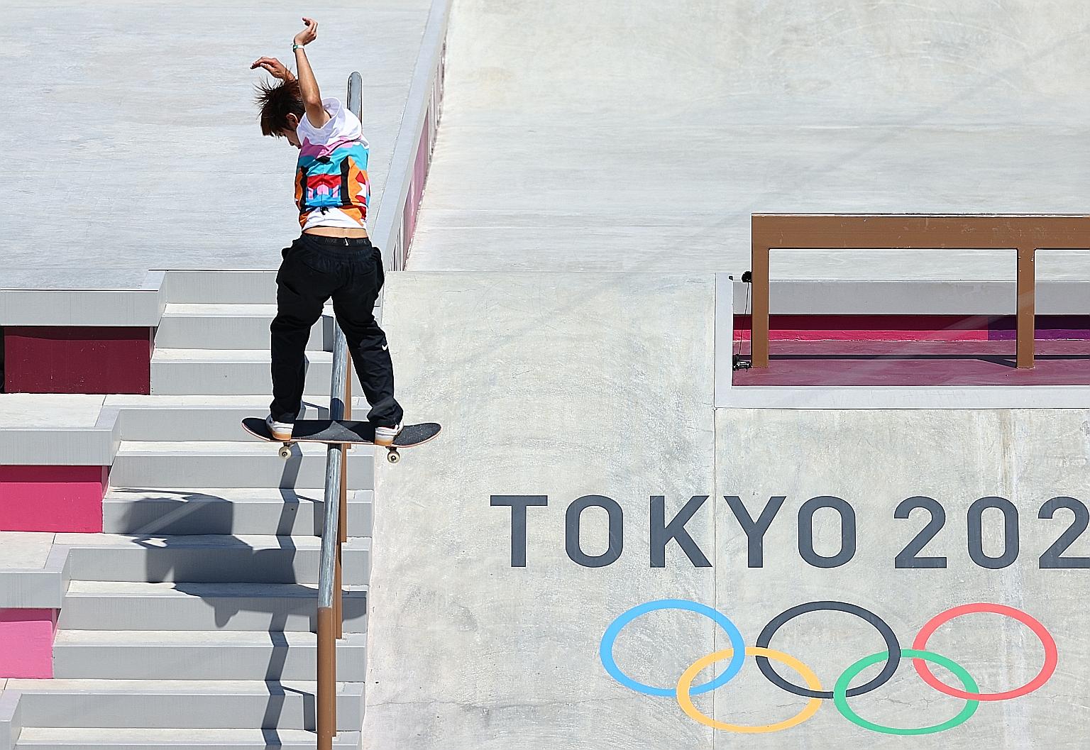 Japan's Yuto Horigome sliding down the stair handrails in the men's skateboarding street preliminaries at Ariake Urban Sports Park yesterday. He performed superbly in the tricks after his disappointing runs and scored a total of 37.18 to win the gold