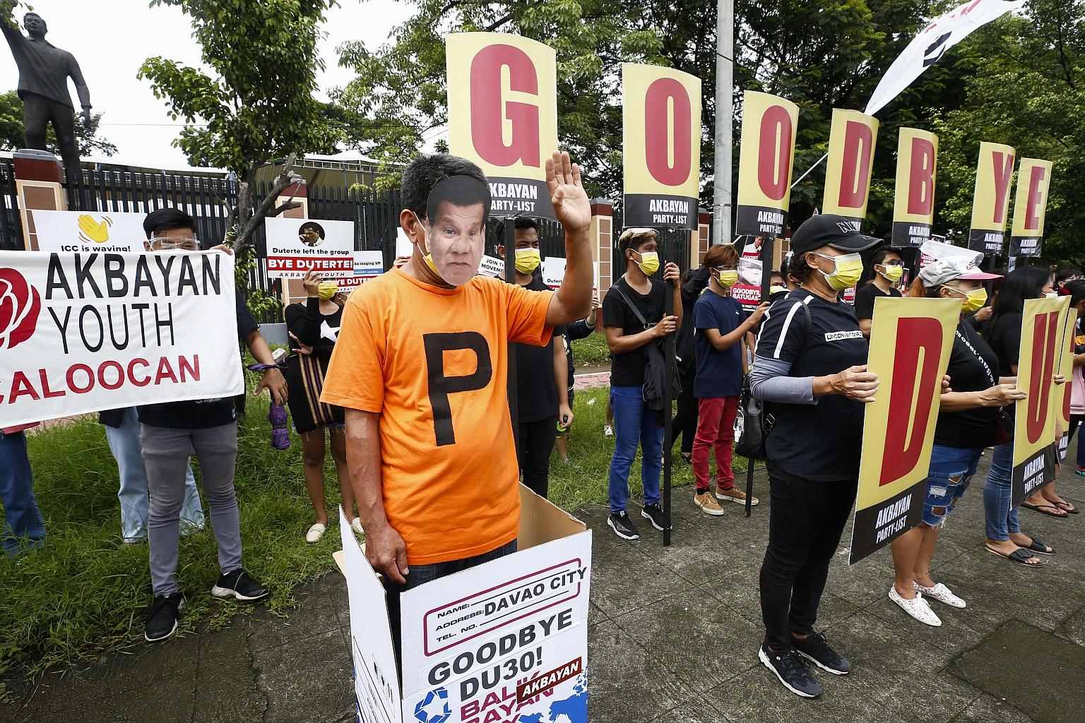 A protester in a Rodrigo Duterte mask waving a symbolic goodbye to the Philippine President outside the Commission on Human Rights in Quezon City, Metro Manila, last week. President Duterte will deliver his last State of the Nation Address of his six
